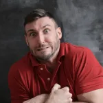 Tell a joke that lands in a packed comedy club.